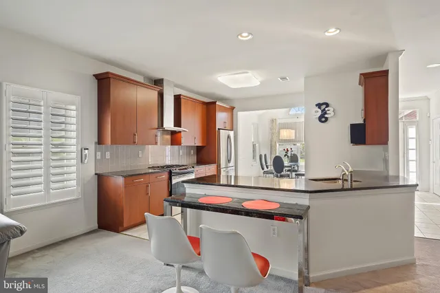 a kitchen with stainless steel appliances granite countertop a sink and cabinets