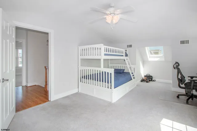 a view of a livingroom with a furniture and ceiling fan