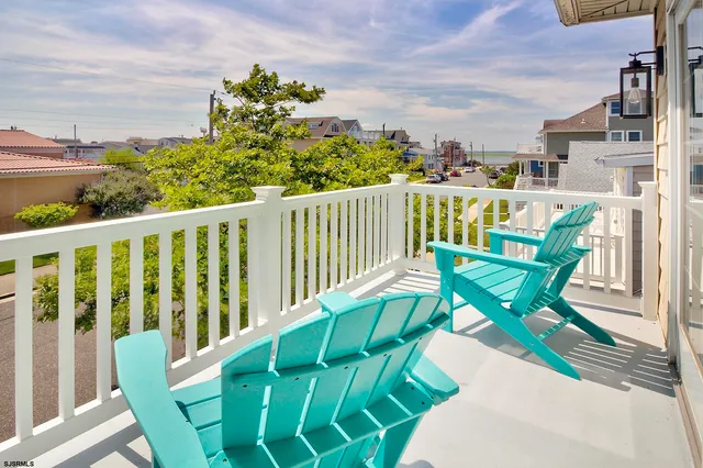 a view of a chairs and table in the balcony