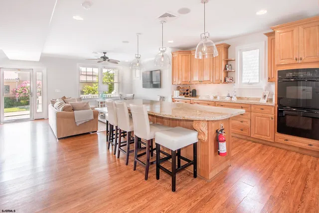 a large kitchen with a table and chairs