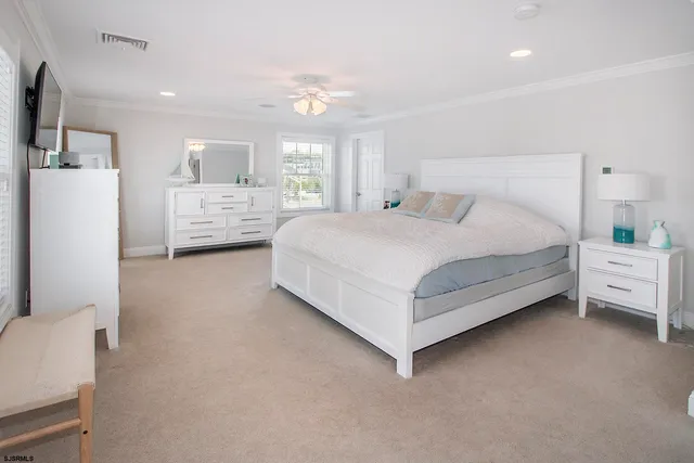 a spacious bedroom with a bed and a large window