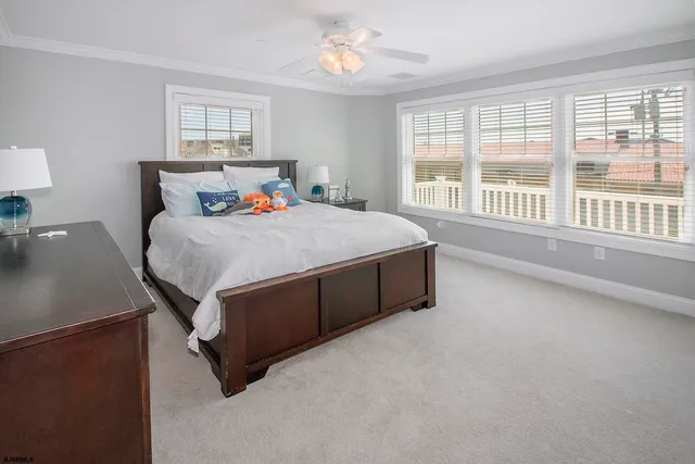 a spacious bedroom with a bed and a window