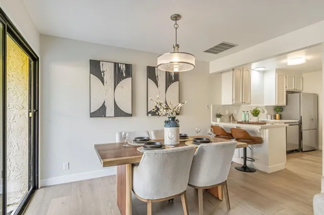 a view of a dining room with furniture window and wooden floor