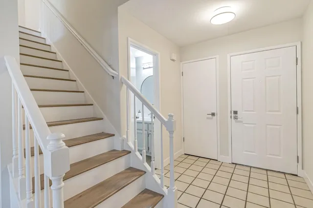 a view of entryway with wooden floor and stairs