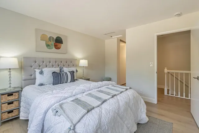 a bedroom with a bed and a lamp