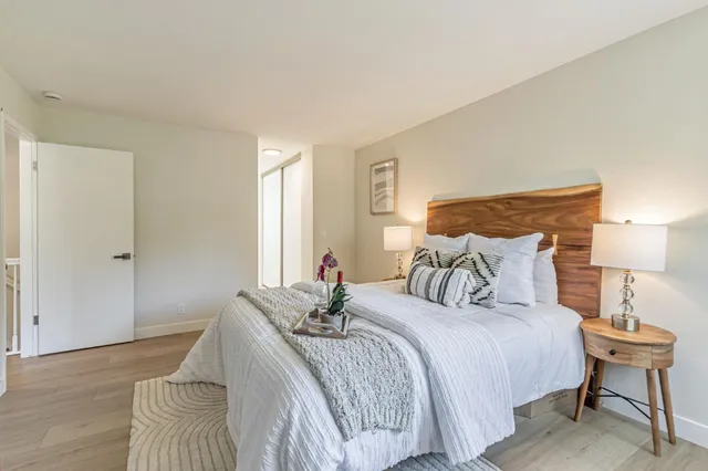 a bedroom with a bed and a night stand