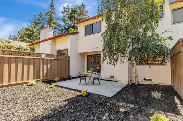 a view of a patio with table and chairs and potted plants