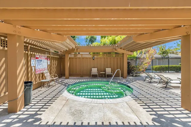 a view of a porch with a table and chairs