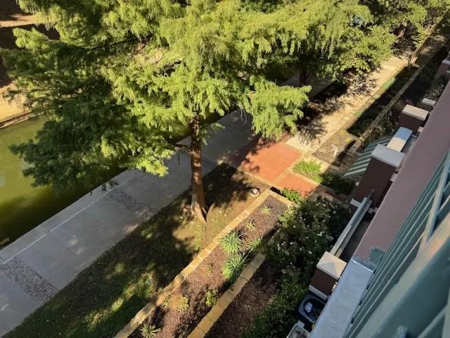 an aerial view of a house with a yard and lake view