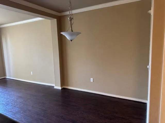 a view of a room with wooden floor