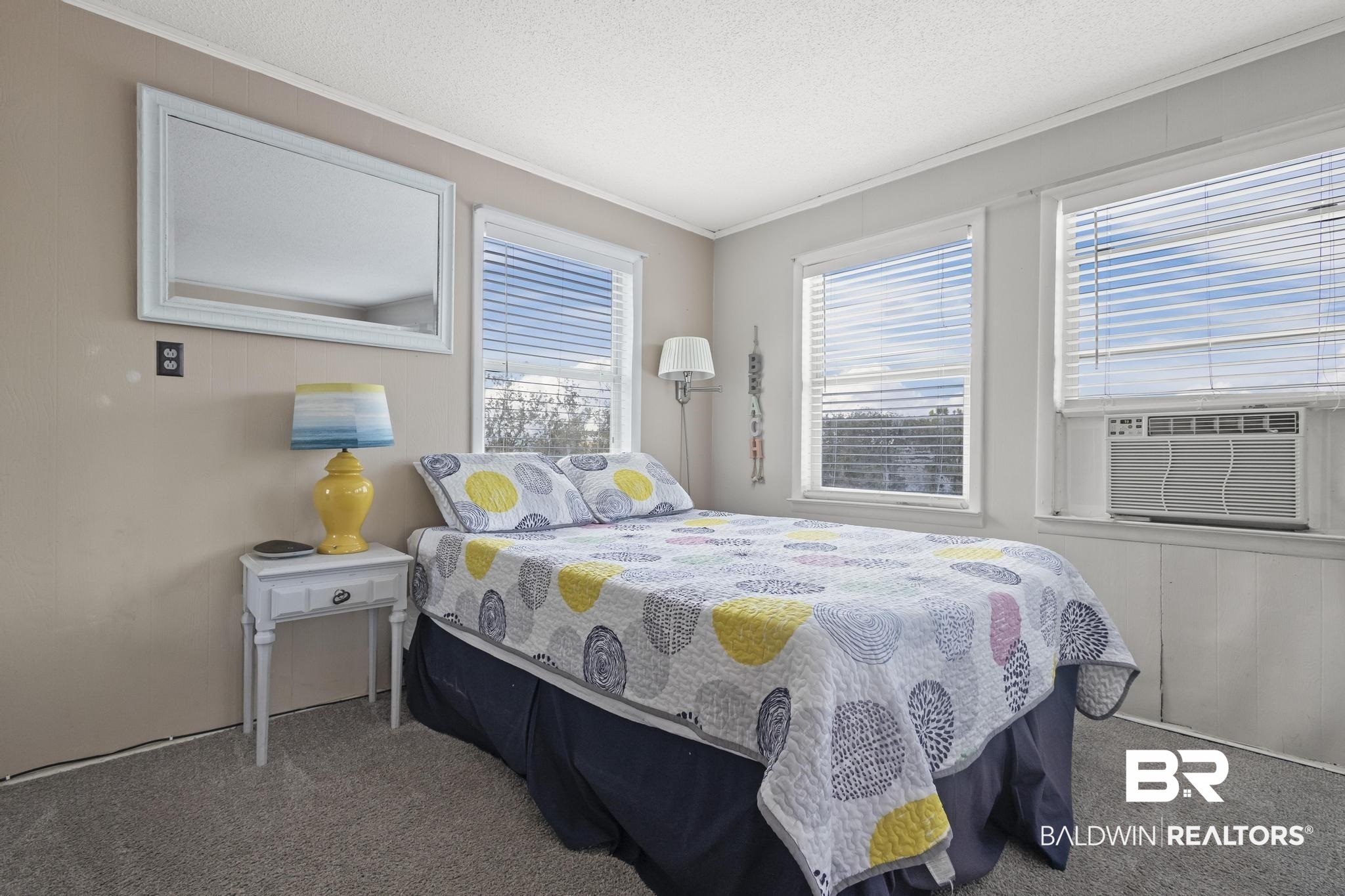 562 Veterans Road Gulf Shores, AL 36542 - Photo 24 of 32 Bedroom with carpet flooring, crown molding, cooling unit, and a textured ceiling