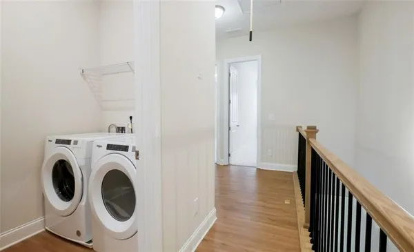 a view of a hallway with wooden floor and chair