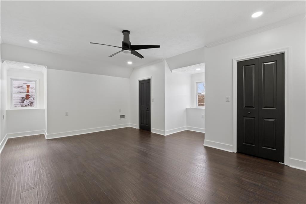 1105 Portland Street Pittsburgh, PA 15206 - Photo 26 of 48 a view of an empty room with wooden floor and a ceiling fan