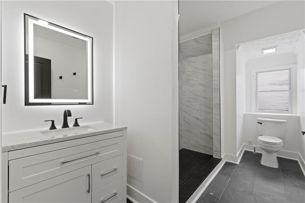 1105 Portland Street Pittsburgh, PA 15206 - Photo 29 of 48 a bathroom with a toilet sink and mirror