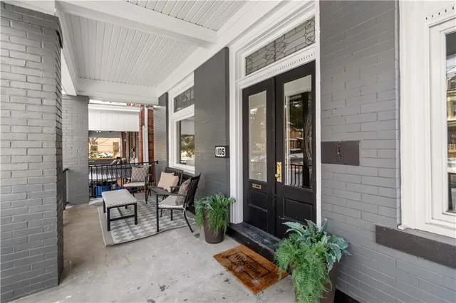 a lobby with furniture and potted plants