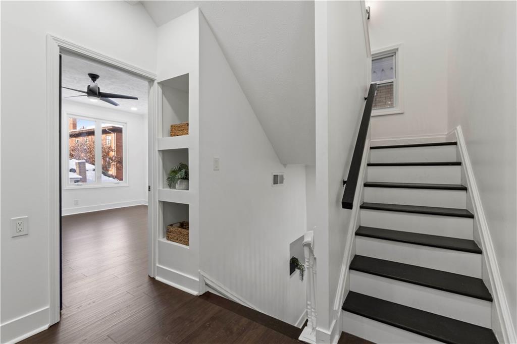 1105 Portland Street Pittsburgh, PA 15206 - Photo 34 of 48 a view of a livingroom with wooden floor and stairs