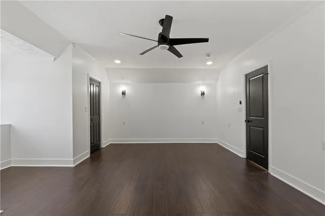 an empty room with wooden floor and closet