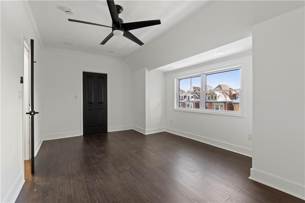 1105 Portland Street Pittsburgh, PA 15206 - Photo 39 of 48 a view of an empty room with wooden floor and a window