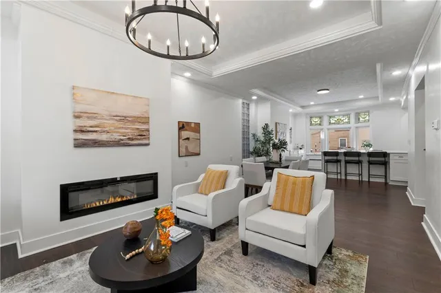 a living room with furniture a fireplace and a large window