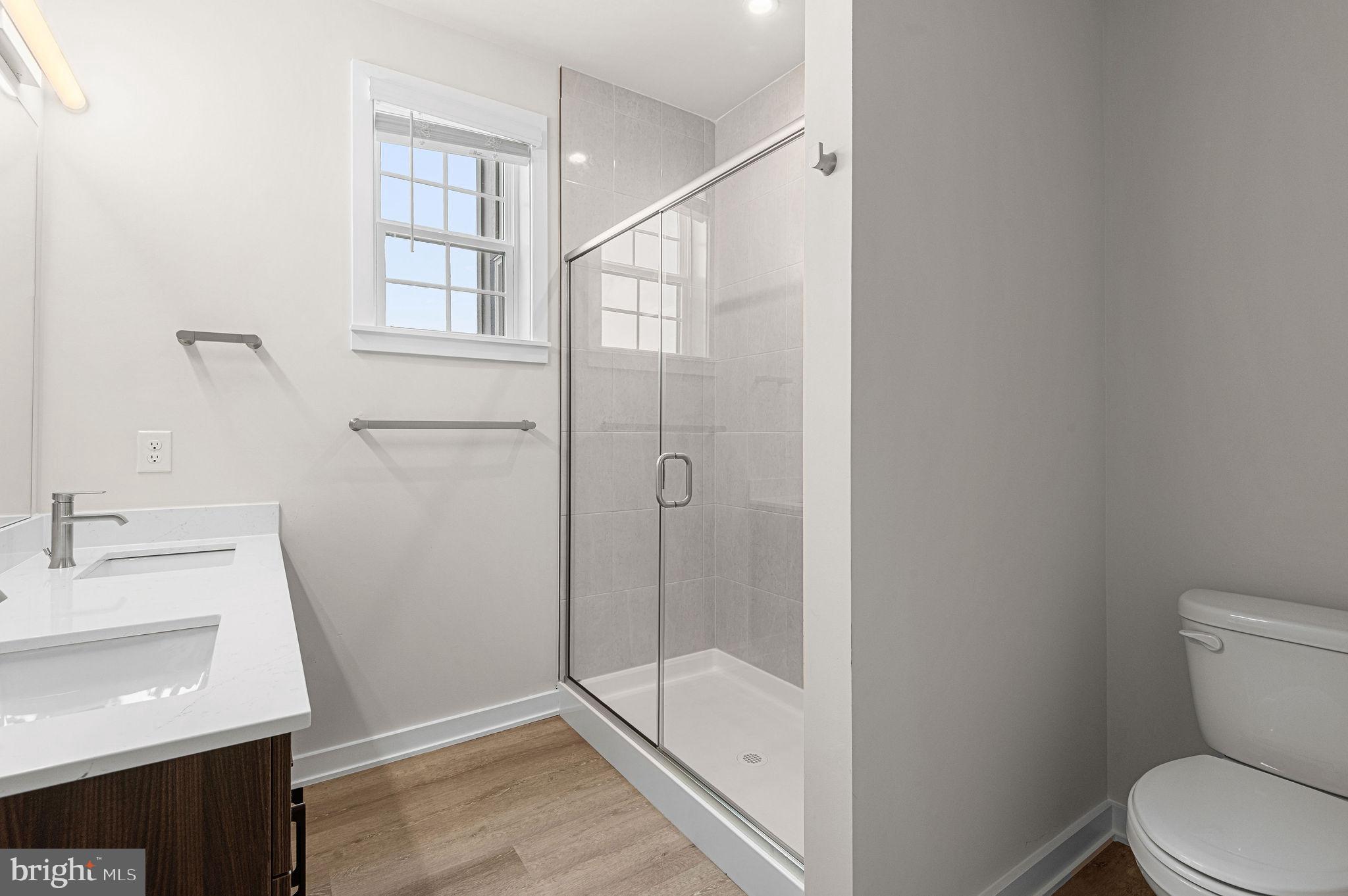 26 South York Road, Unit 410 Hatboro, PA 19040 - Photo 16 of 22 a bathroom with a sink a toilet and shower