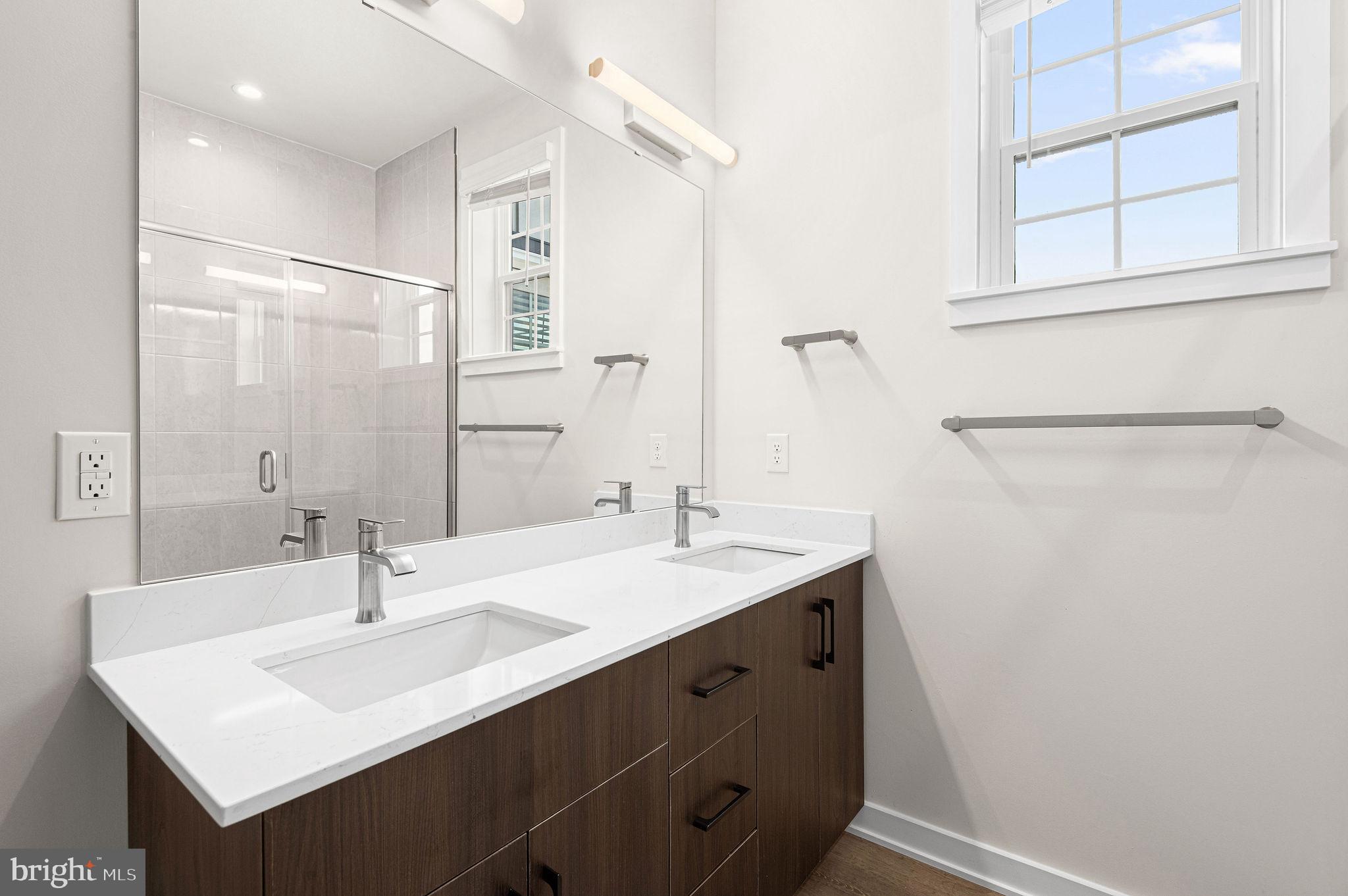 26 South York Road, Unit 410 Hatboro, PA 19040 - Photo 17 of 22 a bathroom with a sink and a mirror