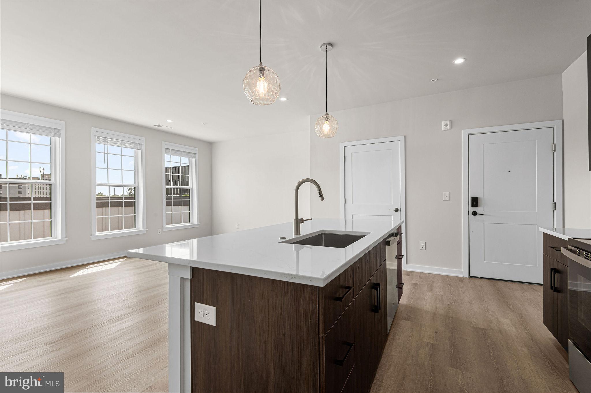 26 South York Road, Unit 410 Hatboro, PA 19040 - Photo 9 of 22 a kitchen that has a sink a window and wooden floor