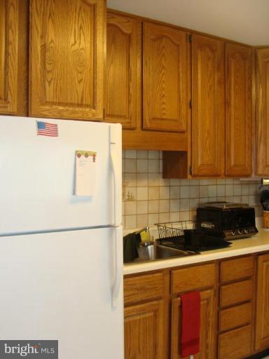 307 Bryanstone Road Reisterstown, MD 21136 - Photo 7 of 25 a kitchen with a sink and cabinets