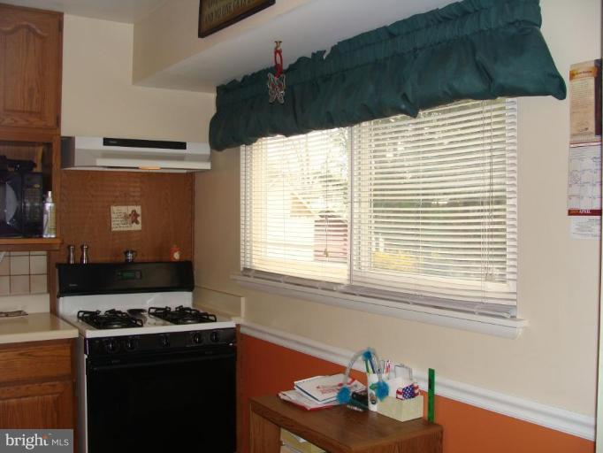 307 Bryanstone Road Reisterstown, MD 21136 - Photo 8 of 25 a kitchen with granite countertop a stove and a white refrigerator