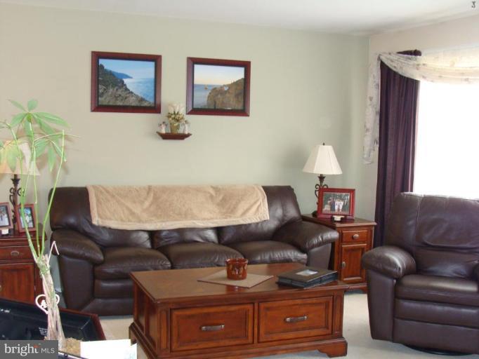 307 Bryanstone Road Reisterstown, MD 21136 - Photo 10 of 25 a living room with furniture and a couch