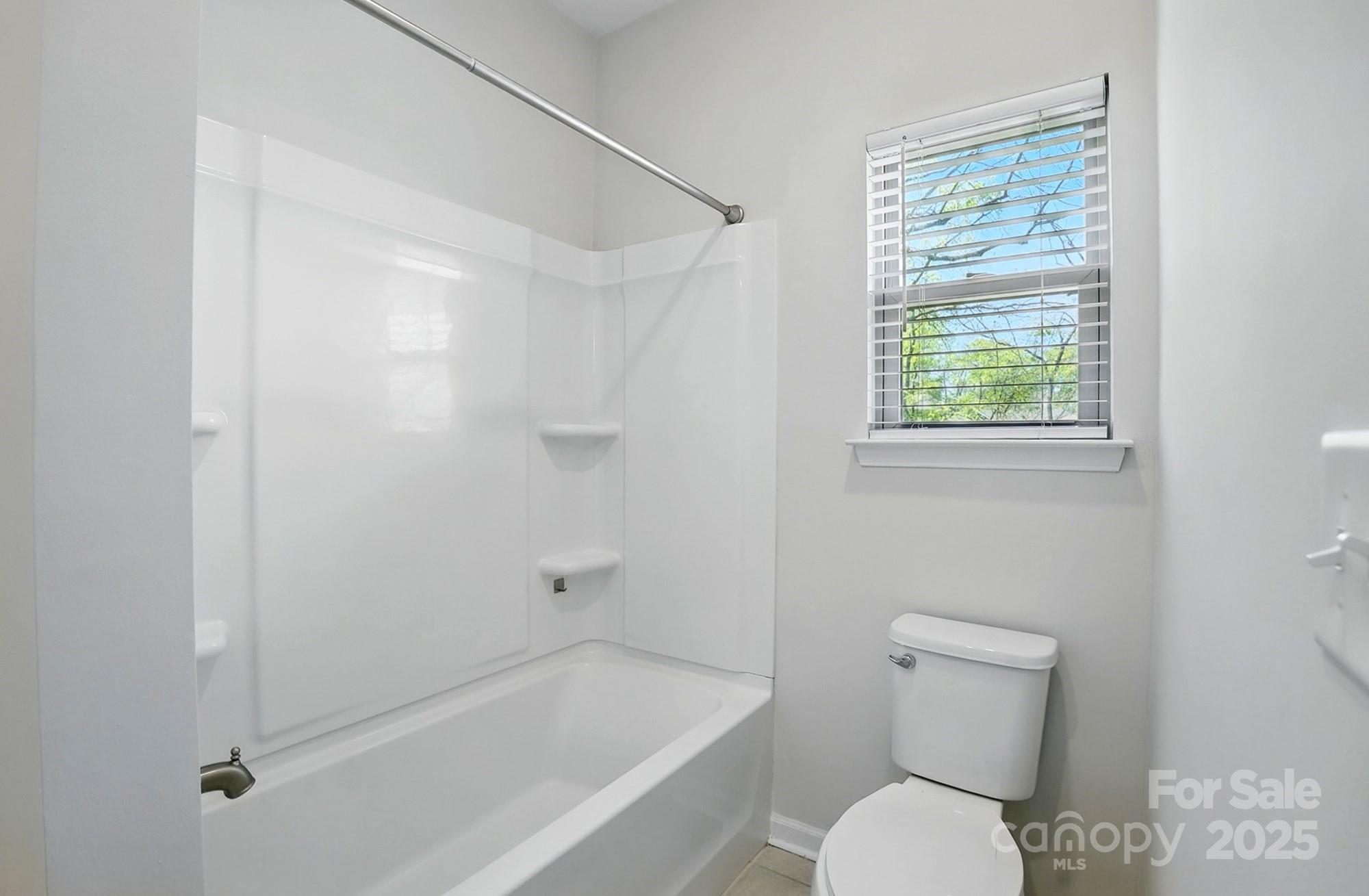 20422 Creek Bend Edge Court Matthews, NC 28105 - Photo 29 of 39 a white toilet sitting next to a bath tub shower