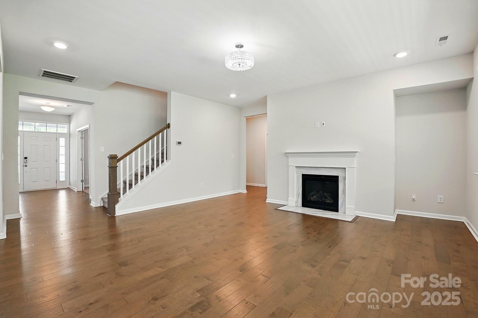 20422 Creek Bend Edge Court Matthews, NC 28105 - Photo 5 of 39 a view of an empty room with wooden floor and a fireplace
