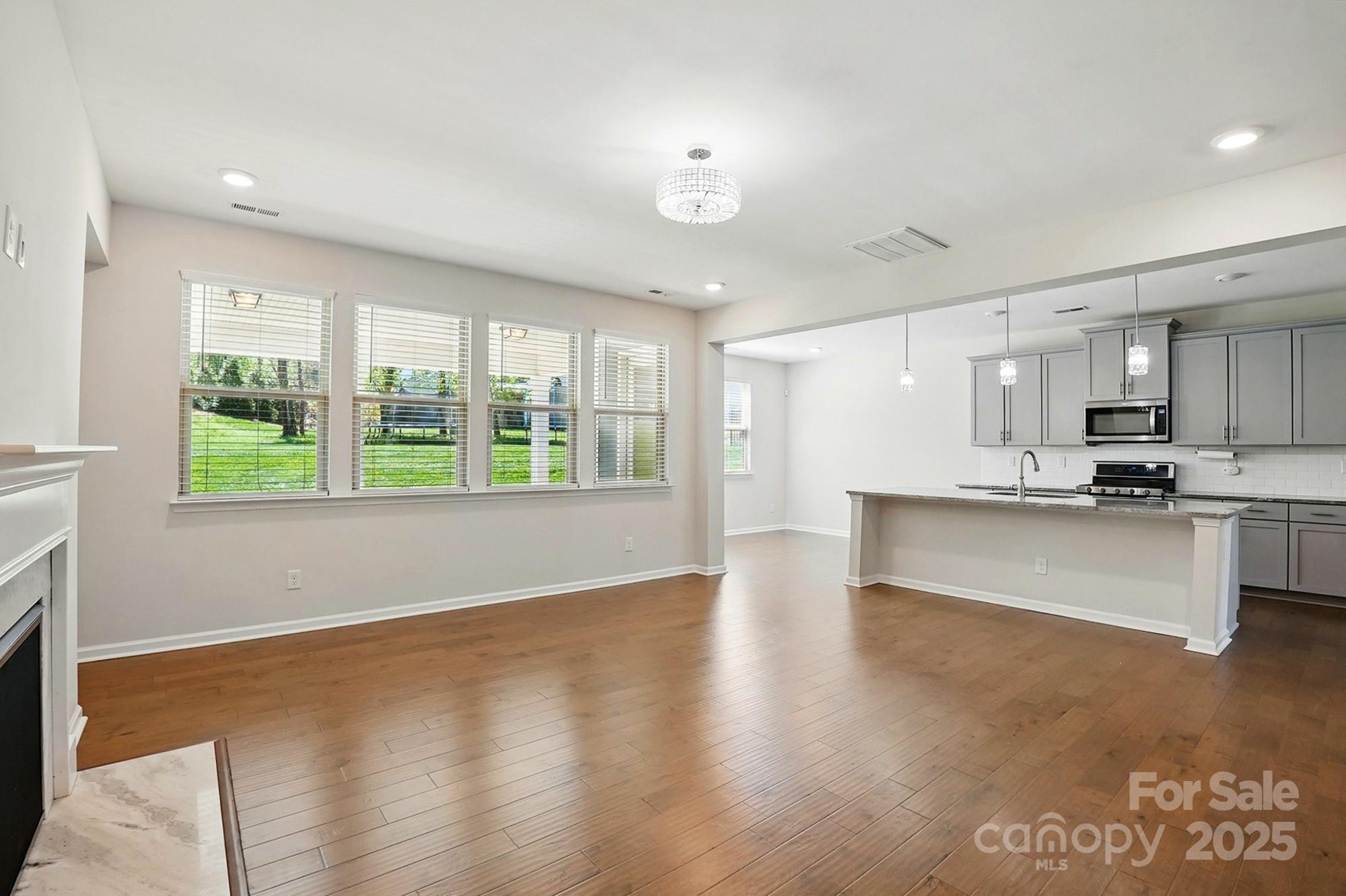 20422 Creek Bend Edge Court Matthews, NC 28105 - Photo 6 of 39 a view of kitchen with kitchen island wooden floor center island and stainless steel appliances