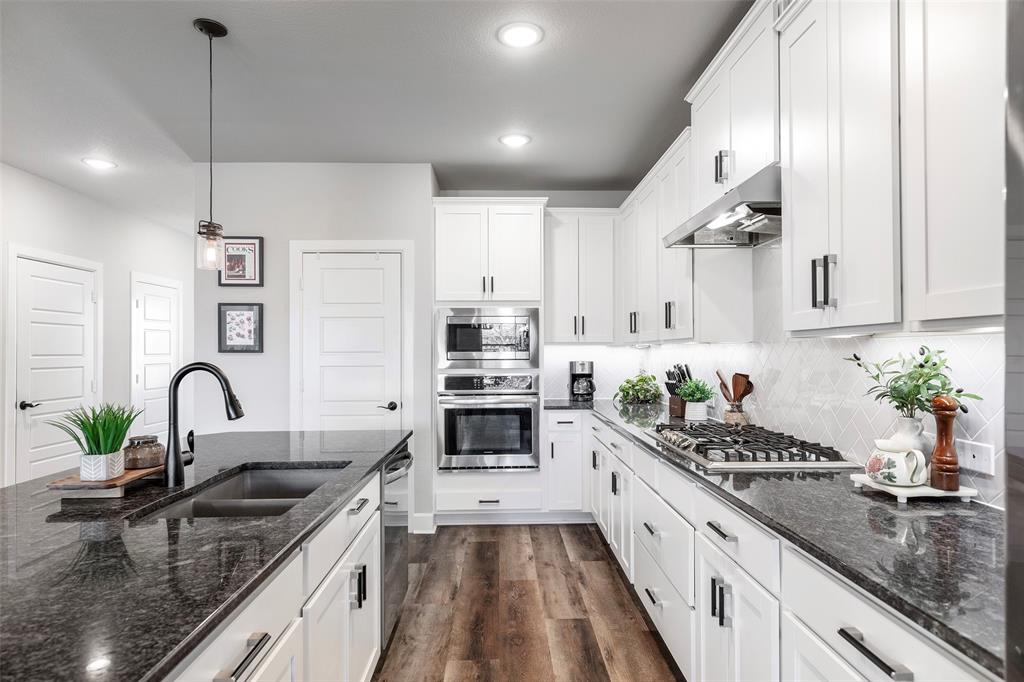 905 Bent Brook Road Little Elm, TX 75068 - Photo 13 of 40 a kitchen with sink a stove and cabinets