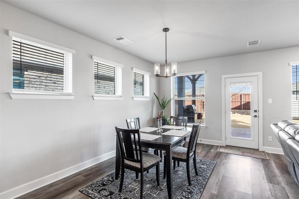 905 Bent Brook Road Little Elm, TX 75068 - Photo 14 of 40 a view of a dining room with furniture window and wooden floor