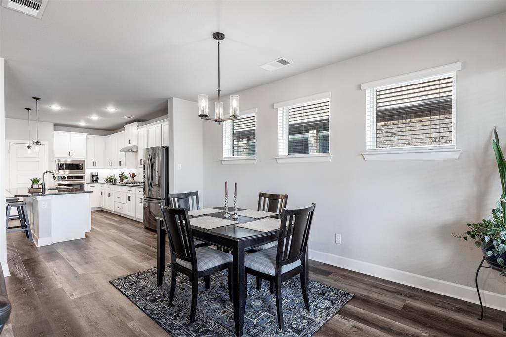 905 Bent Brook Road Little Elm, TX 75068 - Photo 15 of 40 a view of a dining room with furniture window and wooden floor