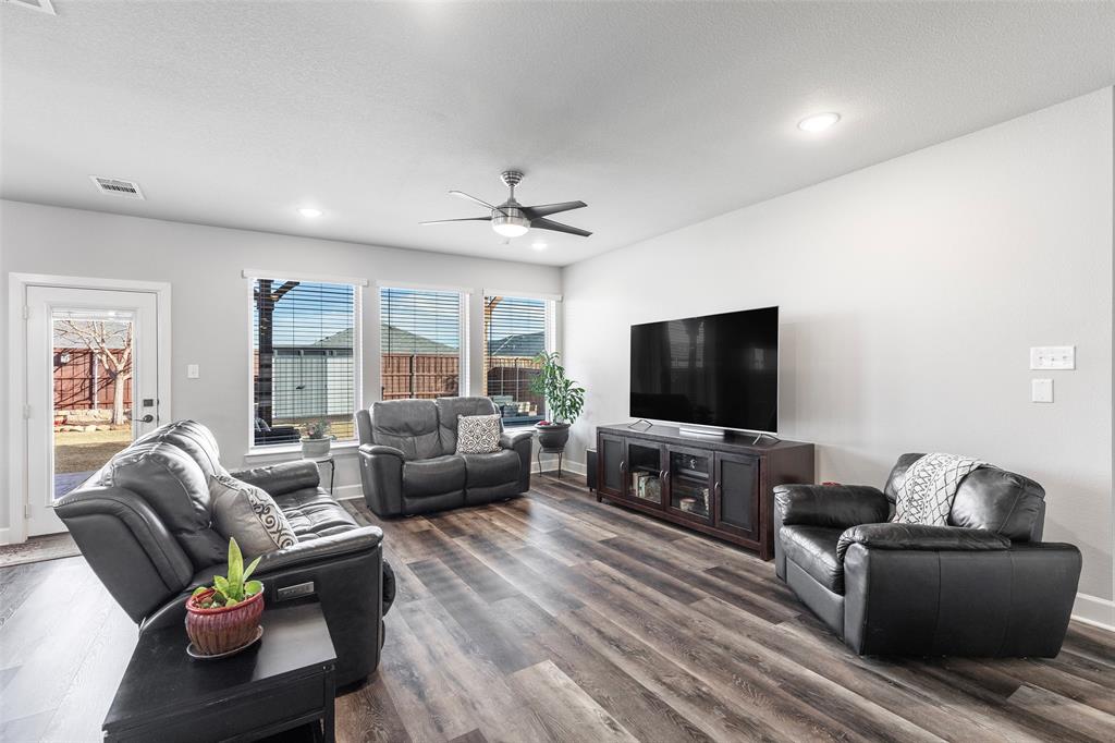 905 Bent Brook Road Little Elm, TX 75068 - Photo 16 of 40 a living room with furniture and a flat screen tv
