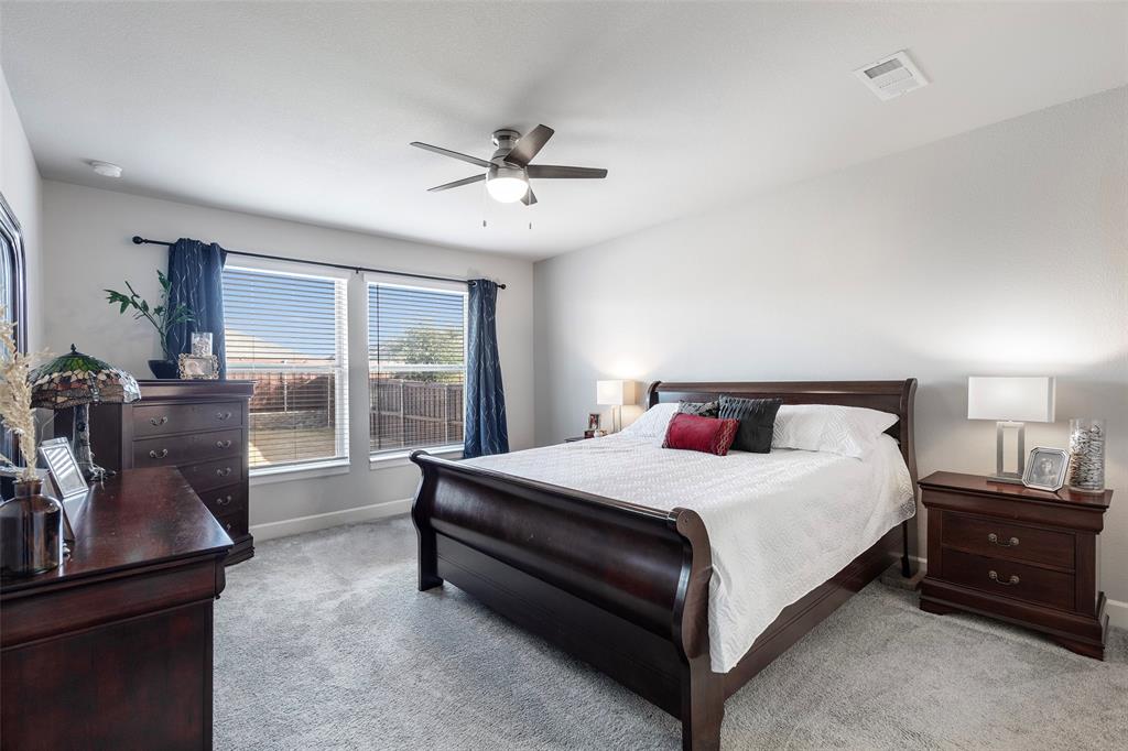 905 Bent Brook Road Little Elm, TX 75068 - Photo 19 of 40 a bedroom with a bed and wooden floor