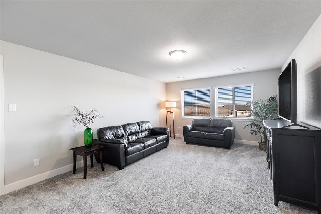 905 Bent Brook Road Little Elm, TX 75068 - Photo 26 of 40 a living room with furniture and a flat screen tv