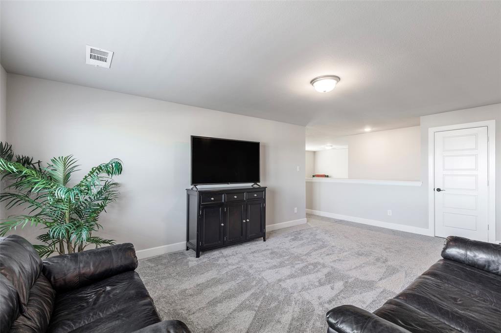905 Bent Brook Road Little Elm, TX 75068 - Photo 27 of 40 a living room with furniture and a flat screen tv
