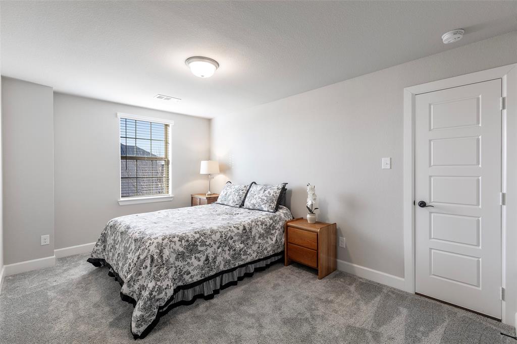 905 Bent Brook Road Little Elm, TX 75068 - Photo 29 of 40 a bedroom with a bed and a window