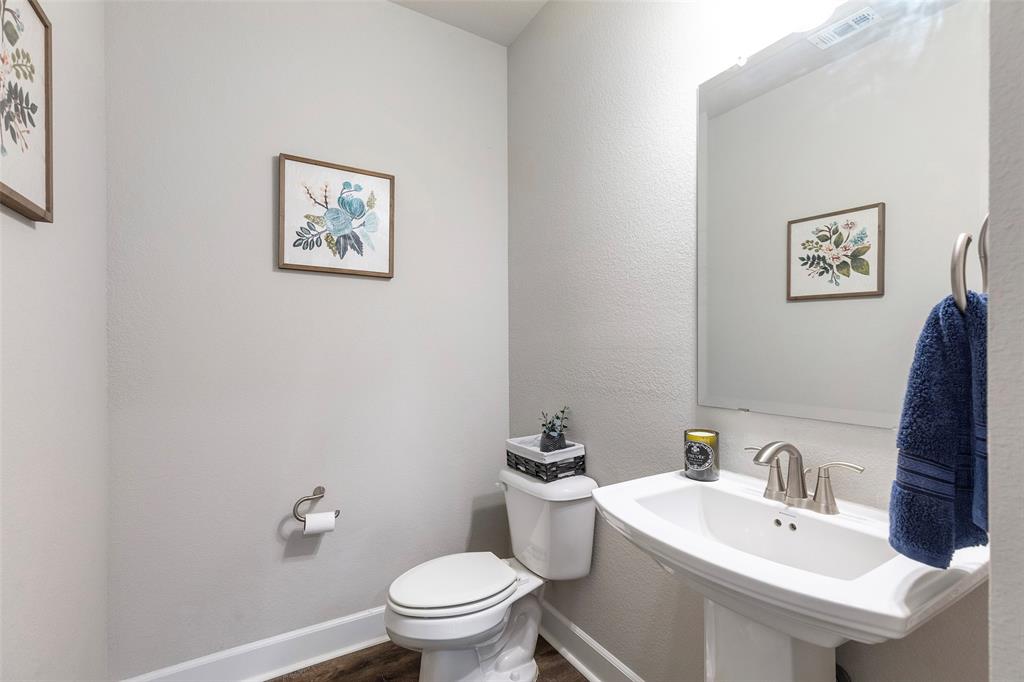 905 Bent Brook Road Little Elm, TX 75068 - Photo 31 of 40 a bathroom with a toilet sink and mirror