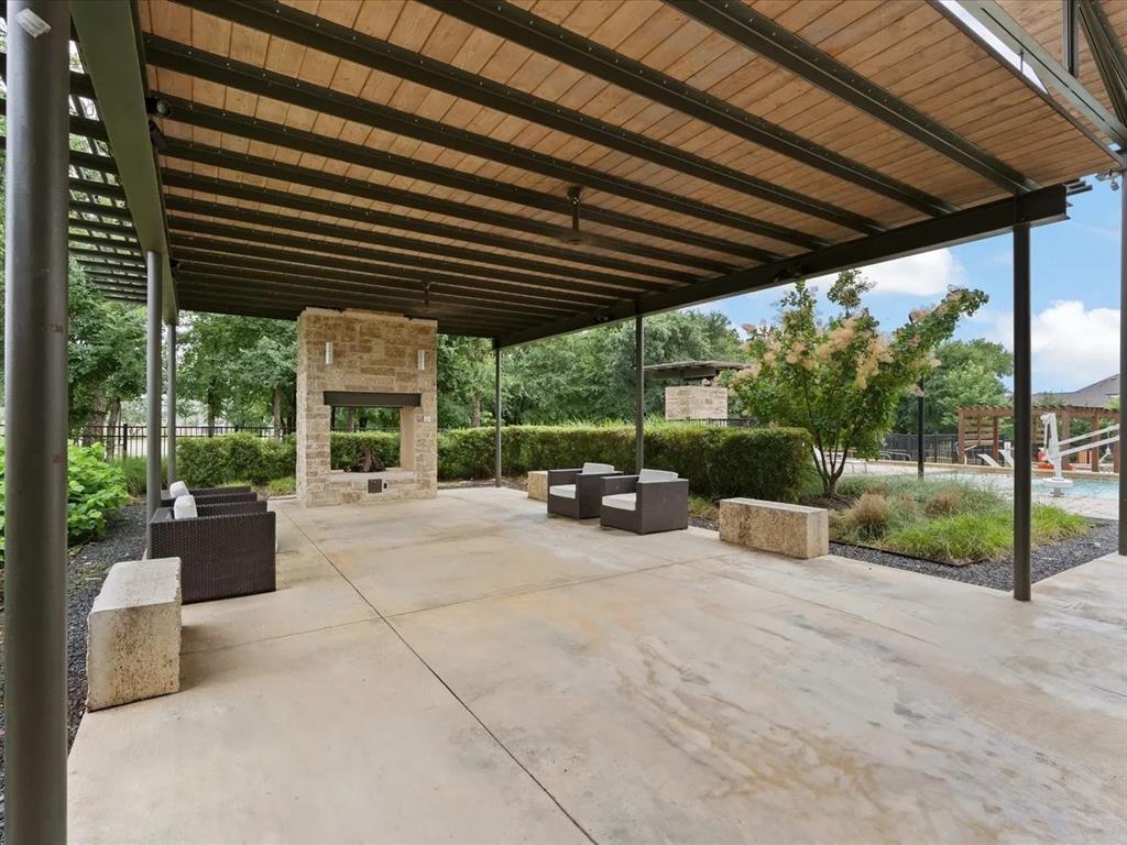 905 Bent Brook Road Little Elm, TX 75068 - Photo 37 of 40 a view of a patio with couches and chairs under an umbrella
