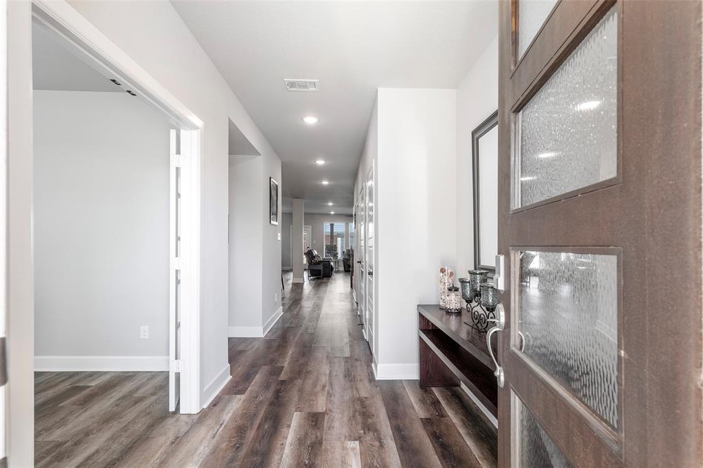 905 Bent Brook Road Little Elm, TX 75068 - Photo 6 of 40 a view of a hallway with wooden floor and furniture