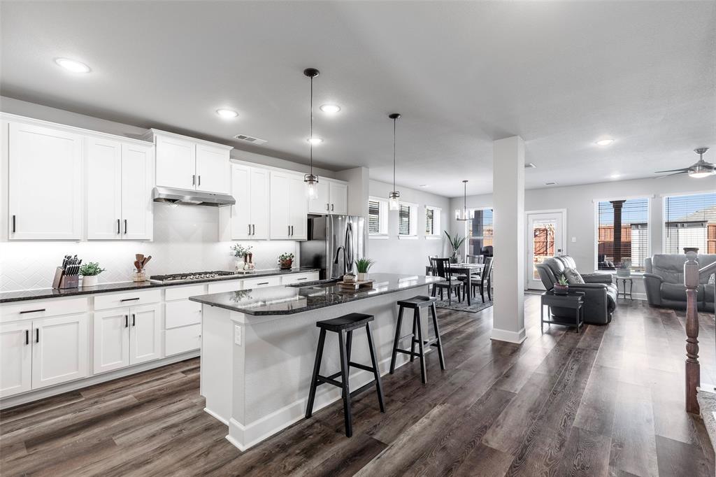 905 Bent Brook Road Little Elm, TX 75068 - Photo 8 of 40 a kitchen with stainless steel appliances granite countertop a lot of counter space dining table and chairs