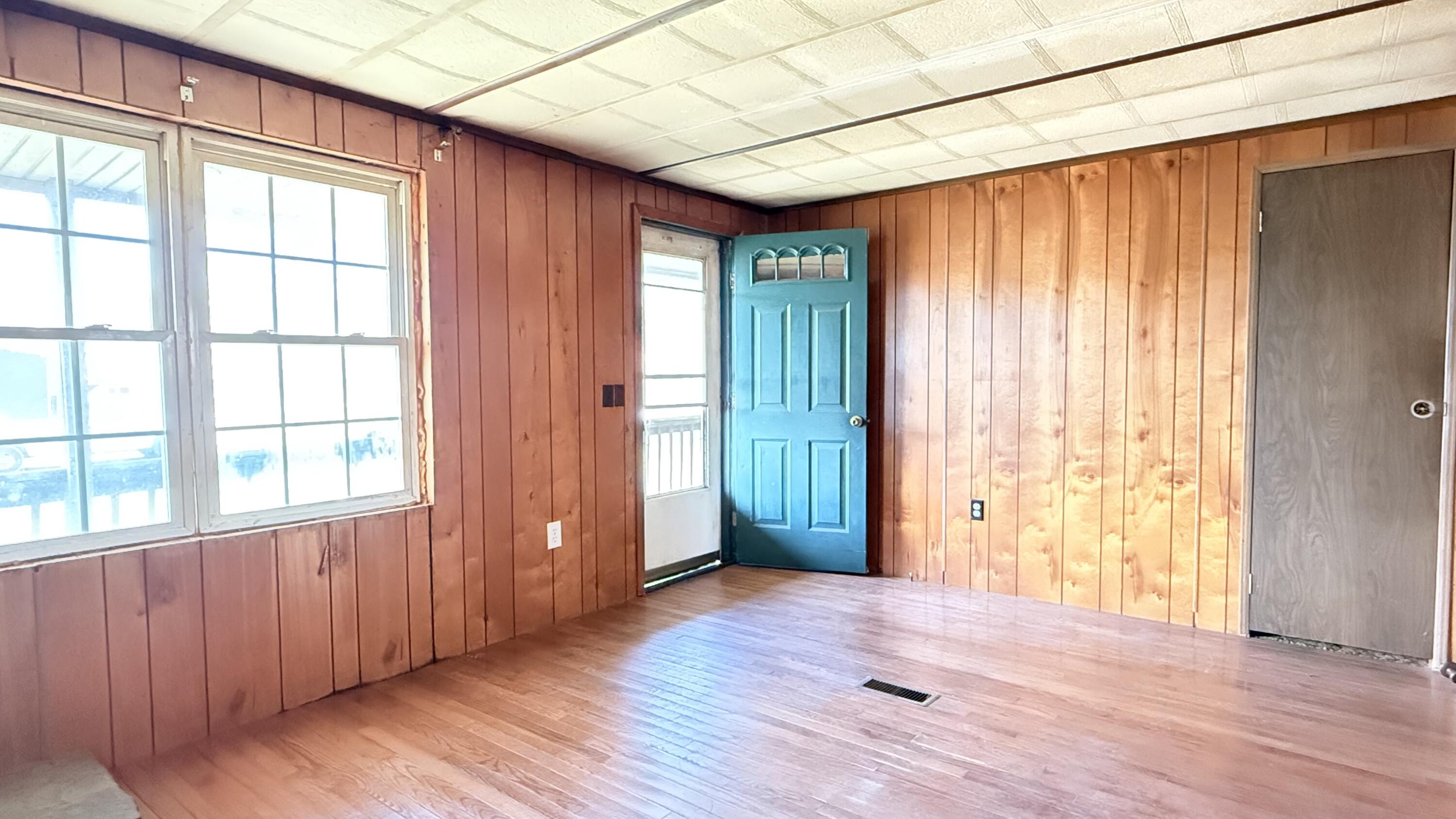 338 4th Street New Castle, VA 24127 - Photo 11 of 23 an empty room with wooden floor and windows