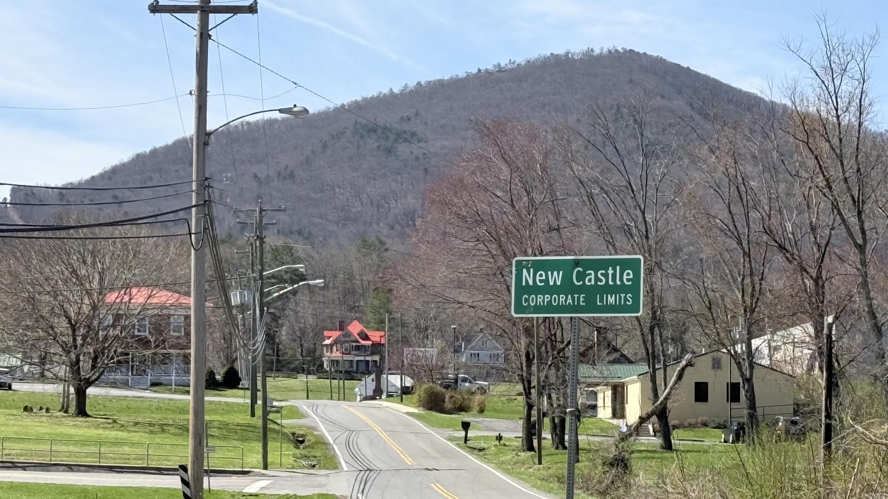 338 4th Street New Castle, VA 24127 - Photo 5 of 23 a street sign on a pole next to a road