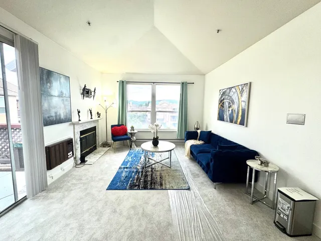 a dining room with furniture potted plants and wooden floor