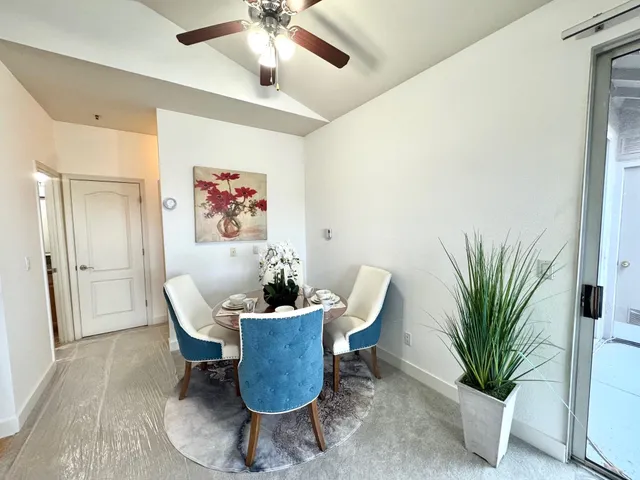a living room with furniture a dining table and kitchen view