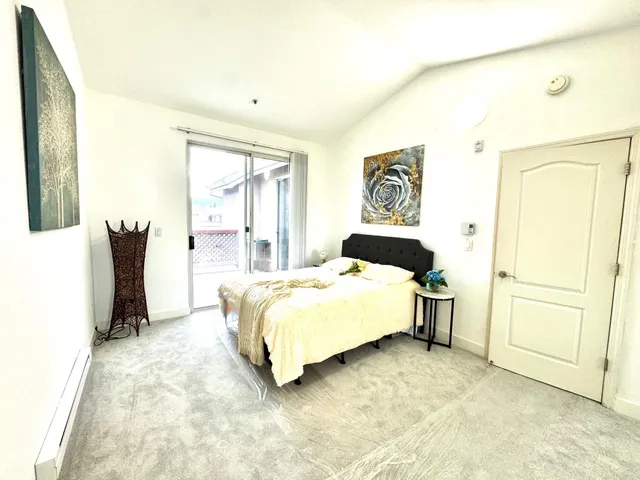 a bed sitting in a bedroom next to a window