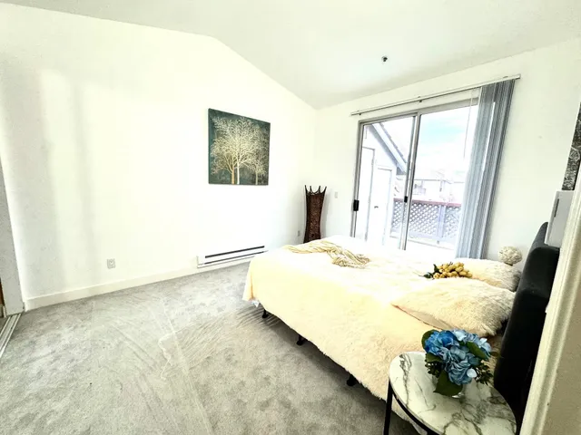 a bedroom with a bed and a couch